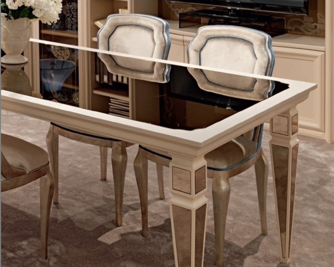 DINING TABLE WITH MIRROR TOP AND ELONGATED PYRAMIDAL SHAPED LEGS