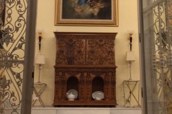 ANTIQUE CABINET WITH RELIEF AND DECORATIVE ARCHES AT THE BOTTOM